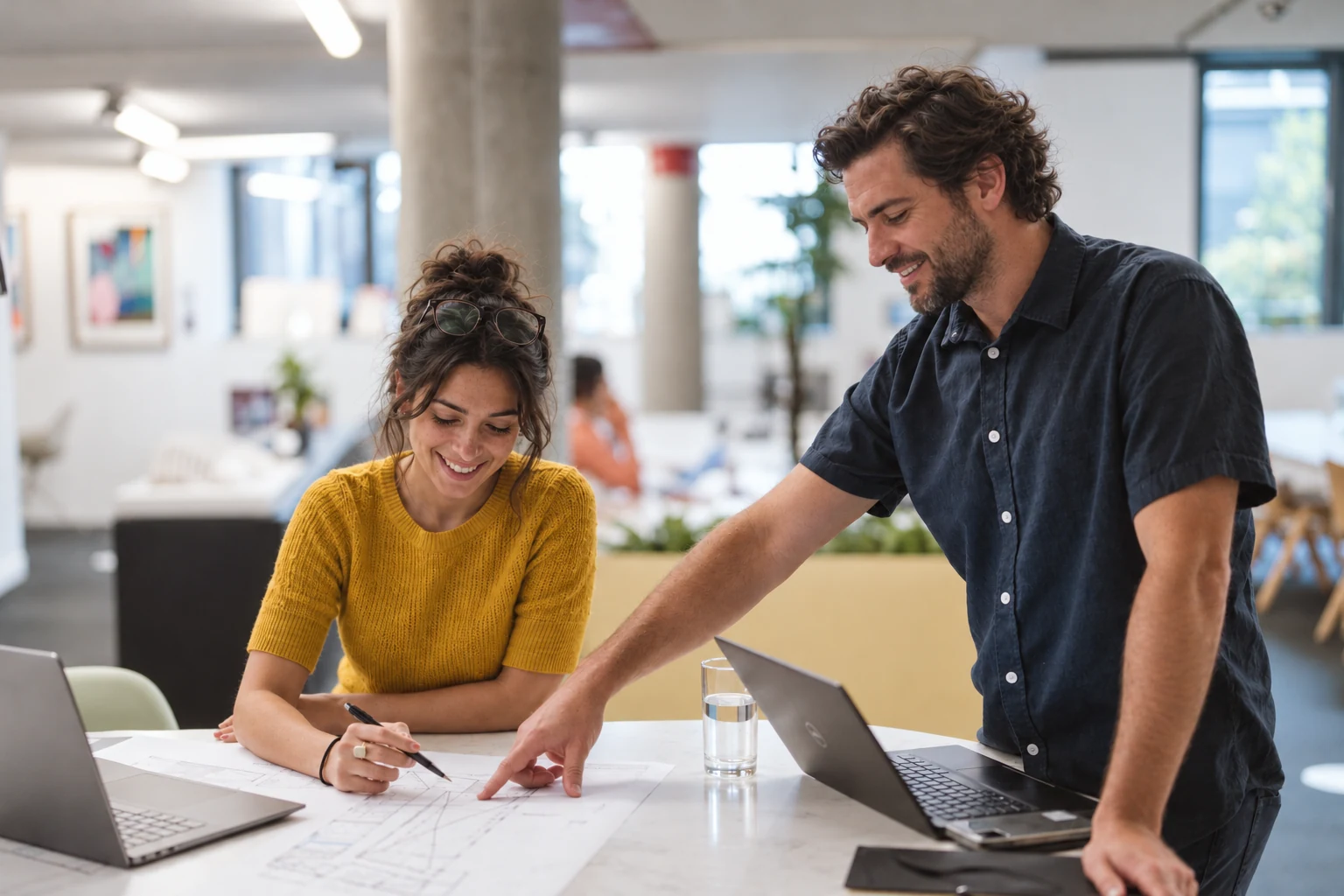 Illustration of two office design professionals reviewing layout drawings together.
