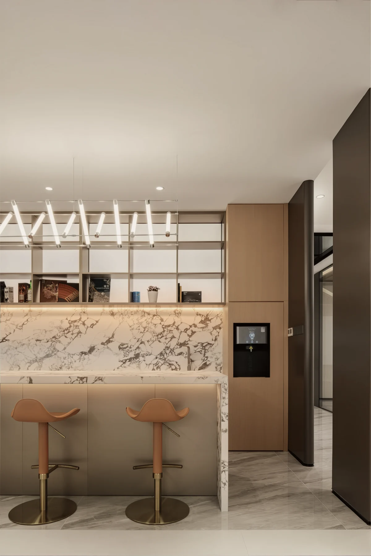 Office pantry with a marble counter, timber cabinetry, pendant lighting and two stools.