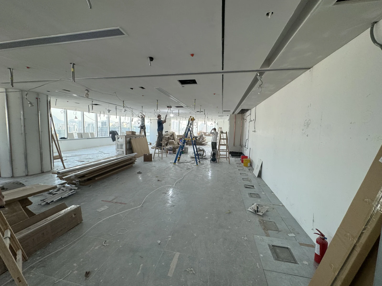 Futurevita Hong Kong open office during building works, with workers, ladders and construction materials.
