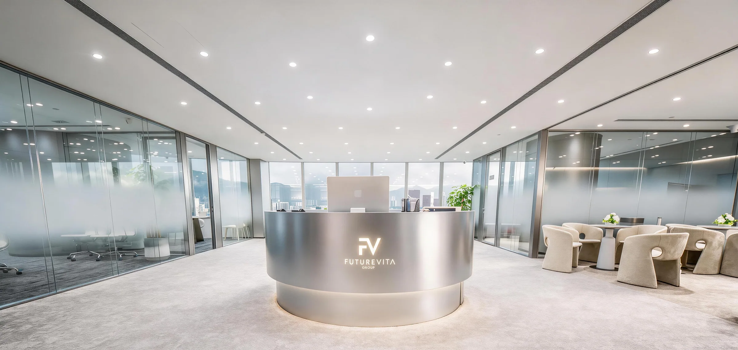 Curved metal reception desk with a brand logo, flanked by glazed rooms and pale lounge chairs.