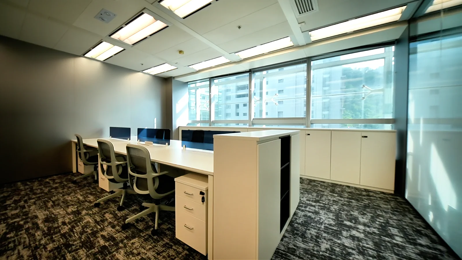 Completed open-plan workstations beside the windows in a Science Park office