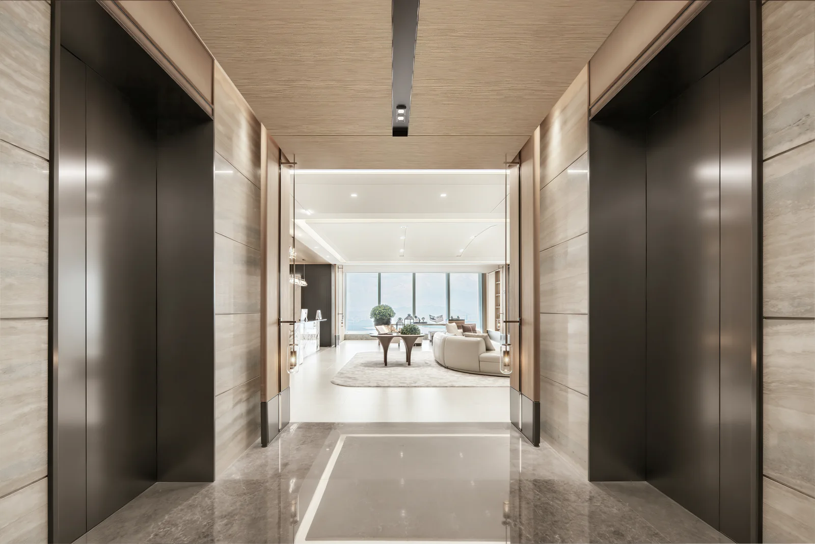 Stone-clad elevator lobby opening toward the lounge in a completed Futian office