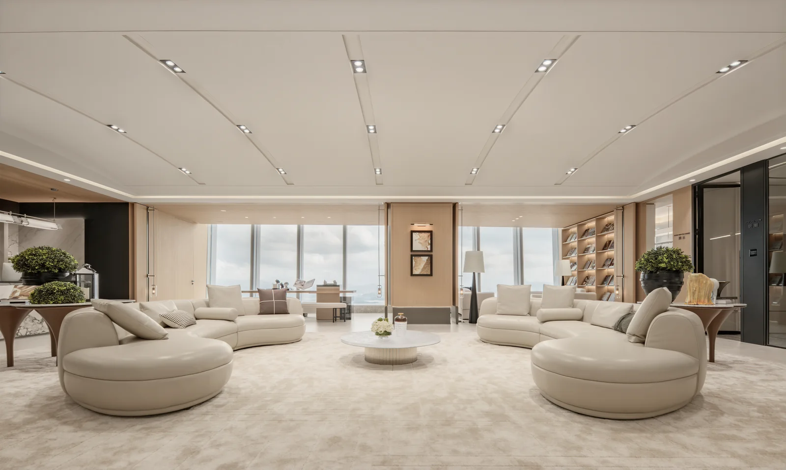 Curved ivory sofas and a round coffee table beside skyline windows in the completed Futian High-Rise Office lounge.